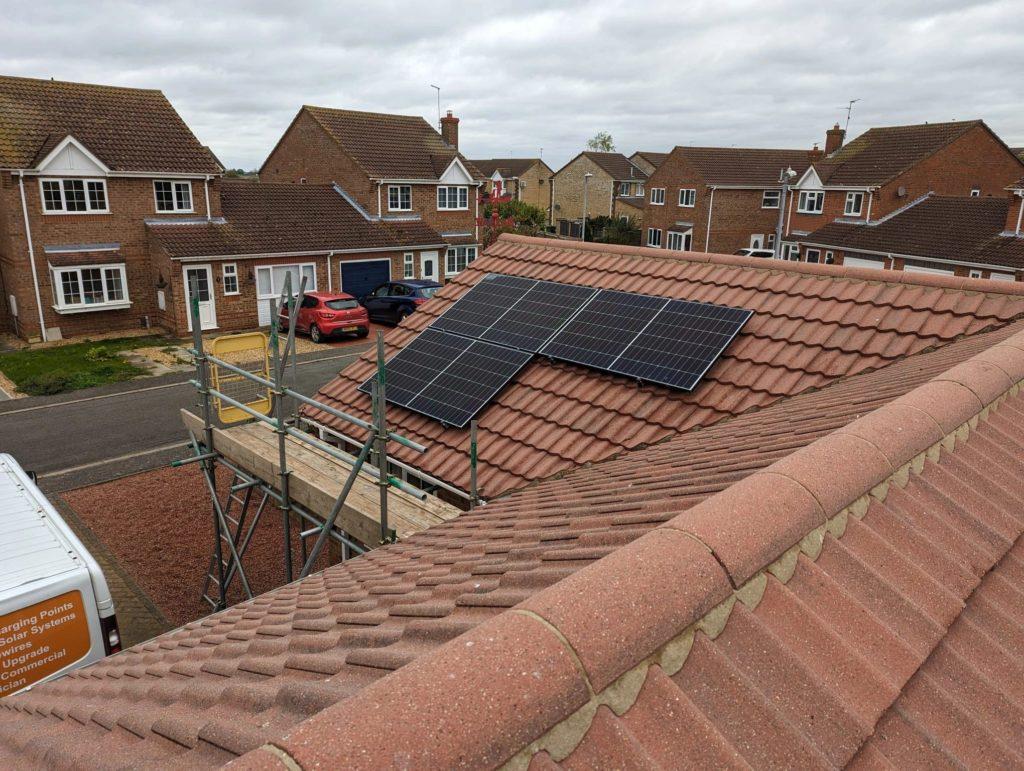 Story Electrical solar panels installation on roof, potentially connected to an EV charger for charging electric car with solar panels